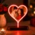 Custom Heart LED Photo Lamp glowing with a personalized couple photo on a wooden base.